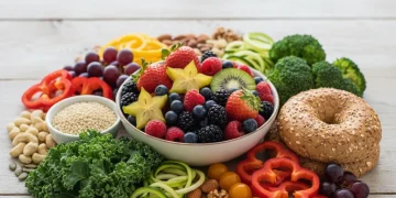 Assortment of fresh fruits, vegetables, nuts, and whole grains on a wooden table, representing healthy eating choices.